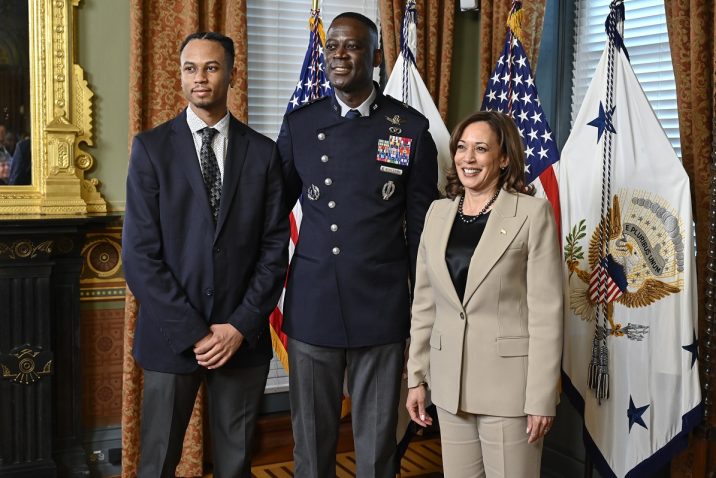 Vice President of the United States stands alongside a brigadier general and another gentleman