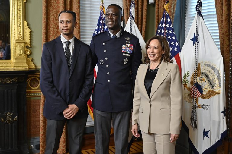 Vice President of the United States stands alongside a brigadier general and another gentleman