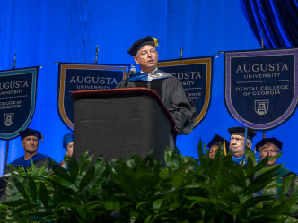Keynote speaker on stage at Augusta University's Spring 2022 Commencement