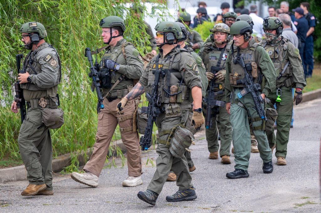 SWAT team members approach a school in a training exercise