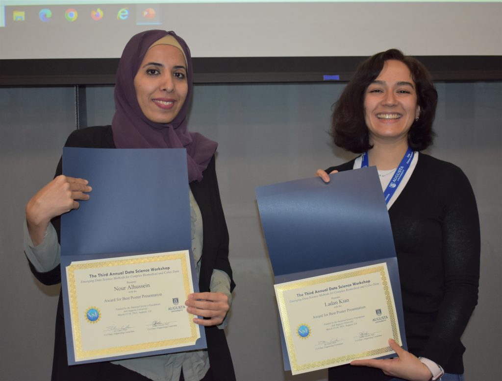 Two women with certificates