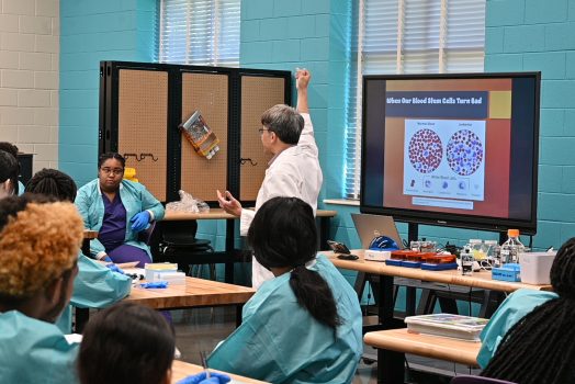 A professor teaches a classroom of students