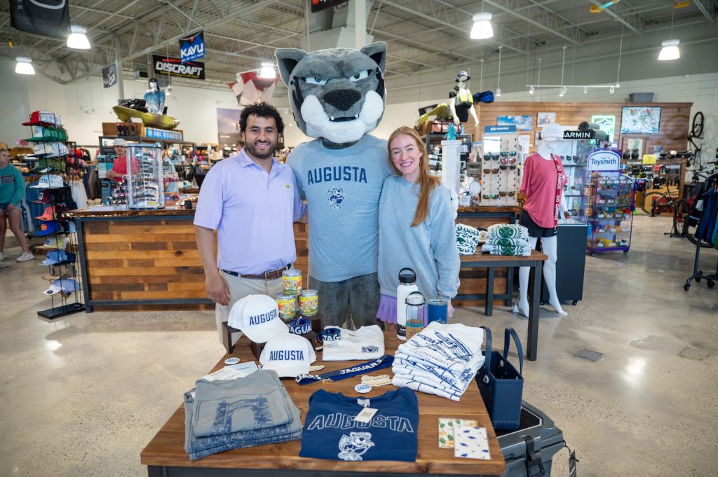 Store owners with Augustus, the mascot