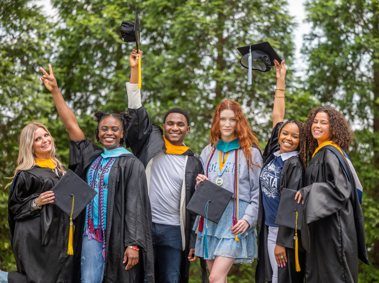 group of students wearing caps and gowns on Augusta University's Summerville Campus