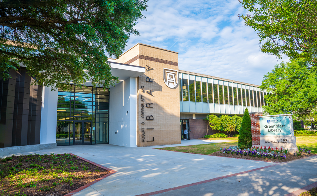 The outside of the Robert B. Greenblatt, M.D. Library with trees lining a sidewalk