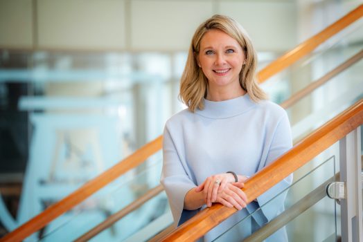 Woman standing on stairs.
