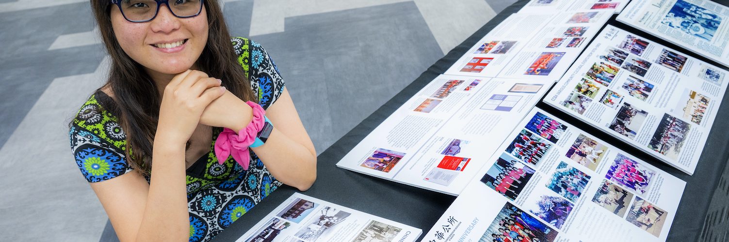 Woman sitting by a historic display