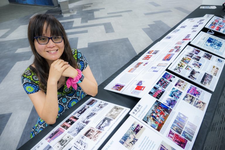 Woman sitting by a historic display