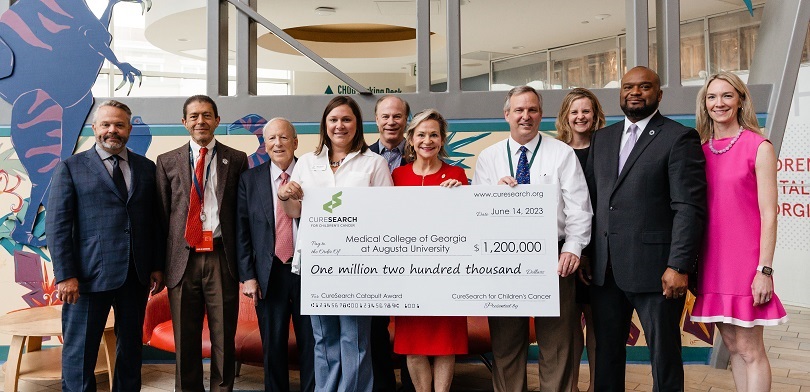 Group of people receiving large check