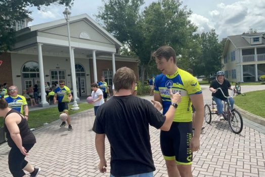 Man smiling, talking with another man
