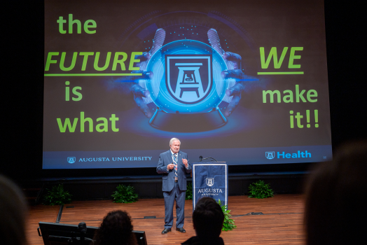 man speaking in a theater