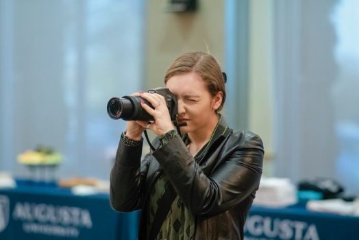 woman with a camera taking a picture