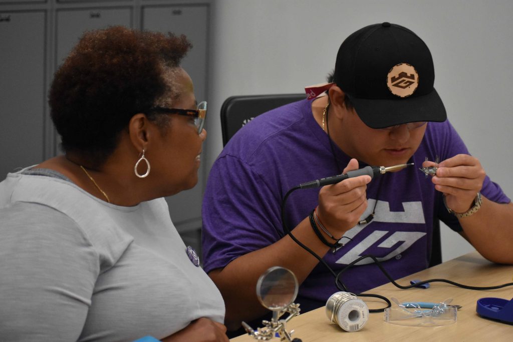 People soldering items