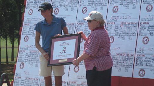 Two women holding a plaque