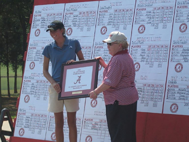 Two women holding a plaque
