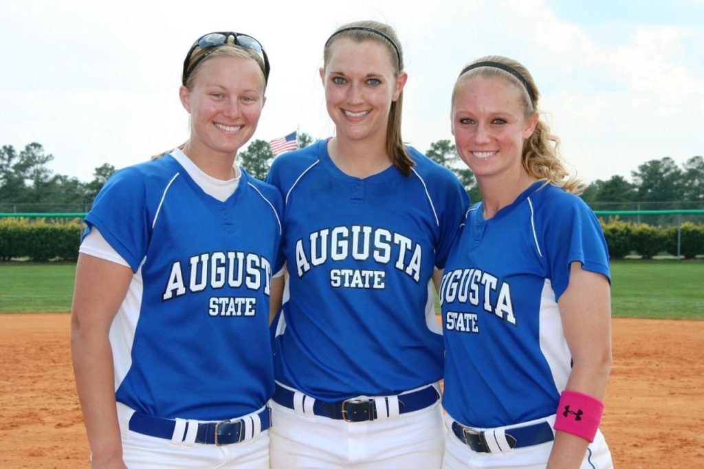 Three women in jerseys smiling