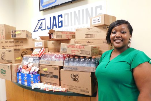 Woman standing by donated food