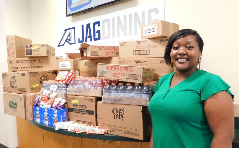 Woman standing by donated food