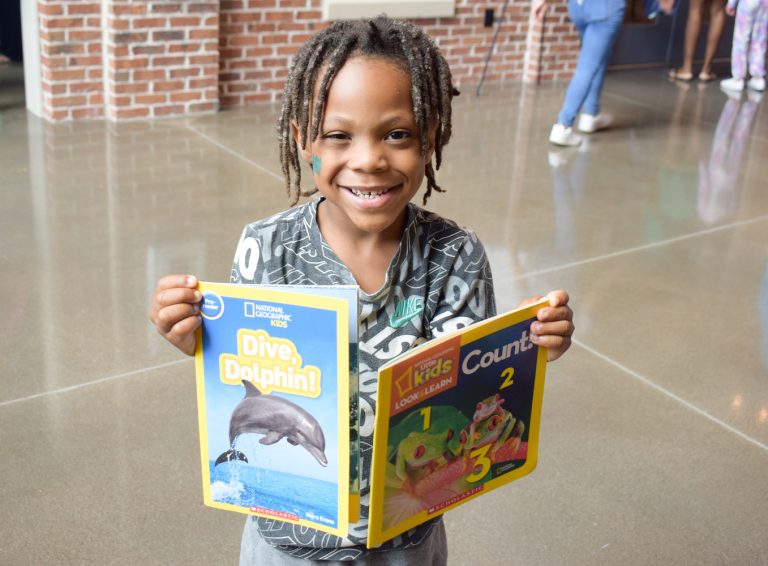 Student holding two books