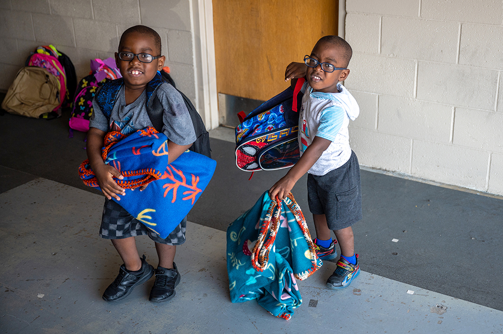 Kids holding backpacks