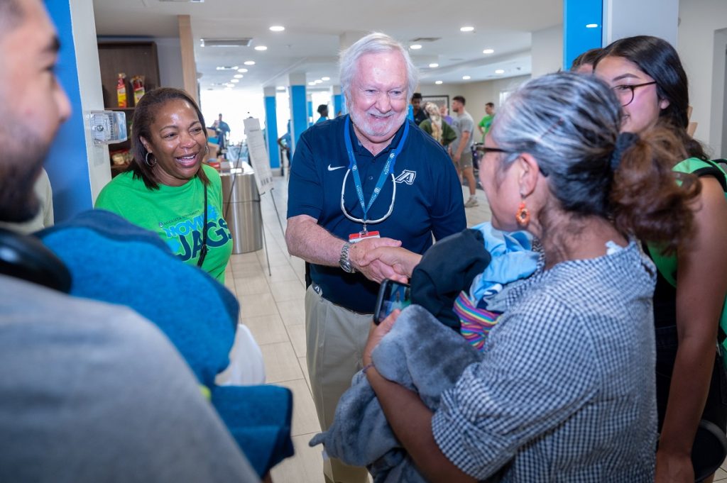 Augusta University President shakes hands with family members 