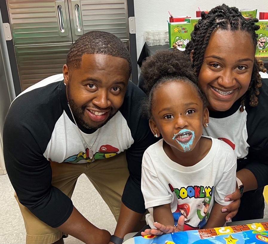 Man and woman with child at birthday party