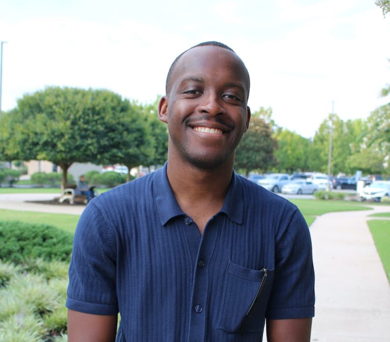 Man standing in a parking lot.