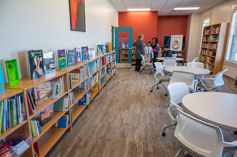 books on shelves and tables for reading