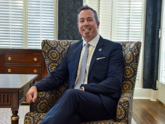 Augusta University Provost Neil MacKinnon sits in chair in his office on the Augusta University Summerville Campus.