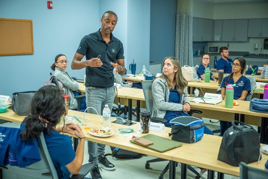 Man talking to students