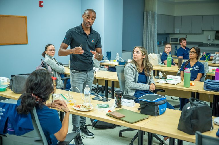 Man talking to students