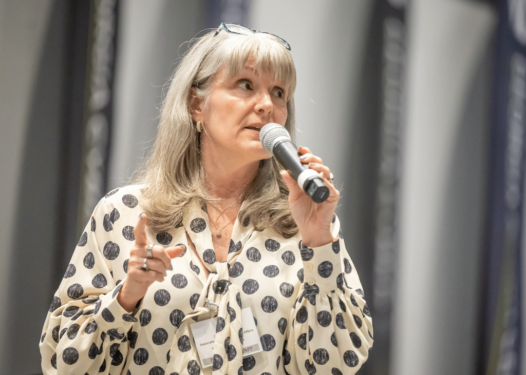 Woman speaks into microphone.