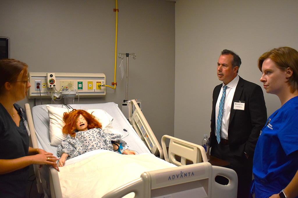 Man and women looking at a simulated patient