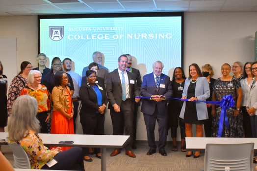 Men and women standing in a line smiling