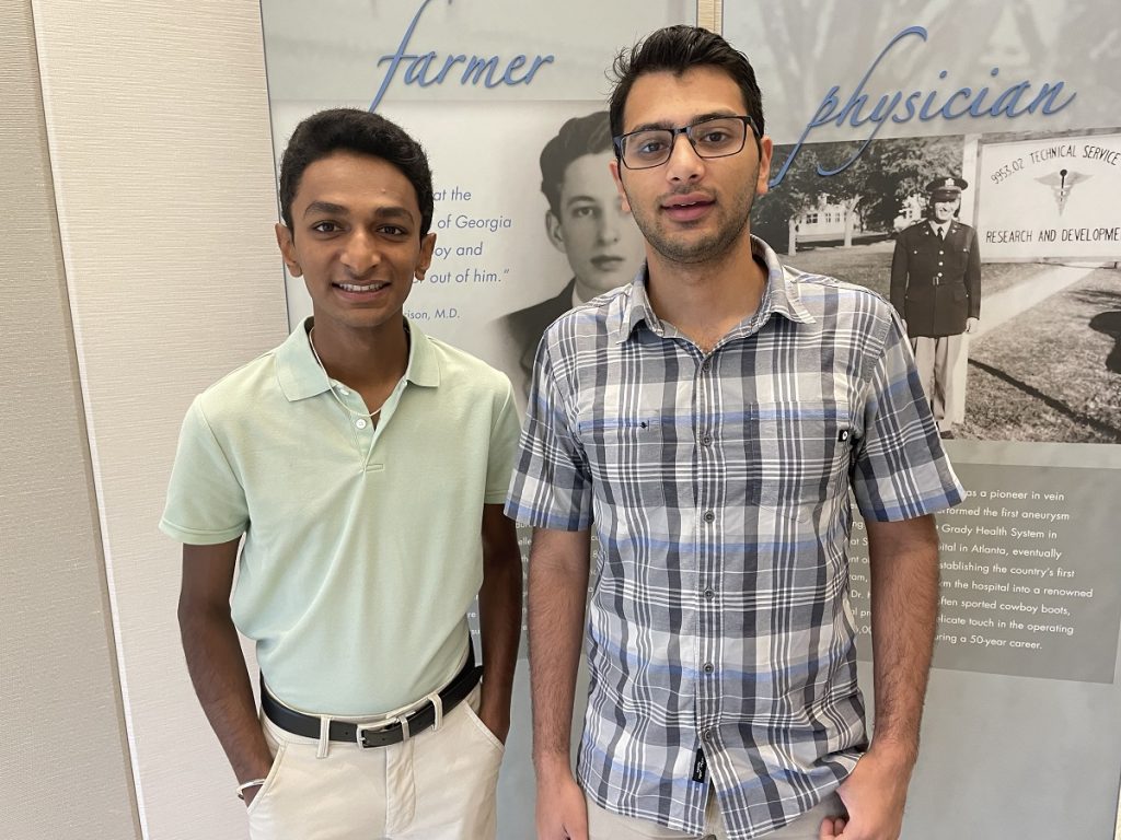 Two young men pose for a photo