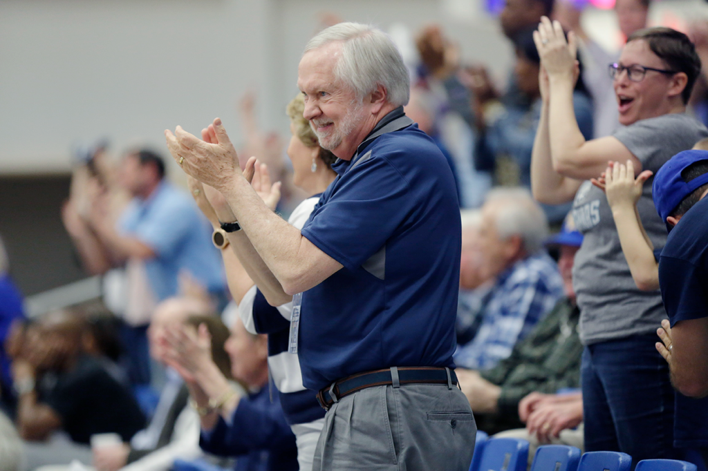 Man clapping at basketball game