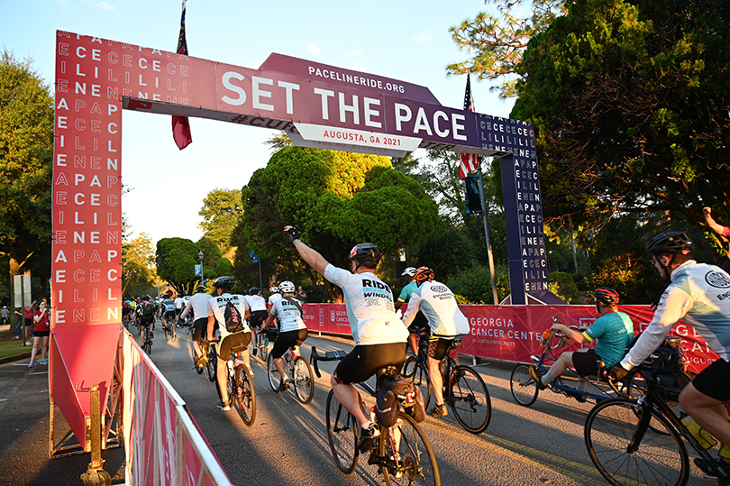 riders cross the Set the Pace finish line in 2021