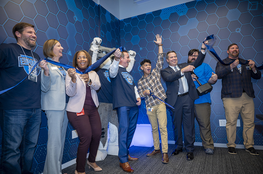 Men and women celebrate a ribbon cutting