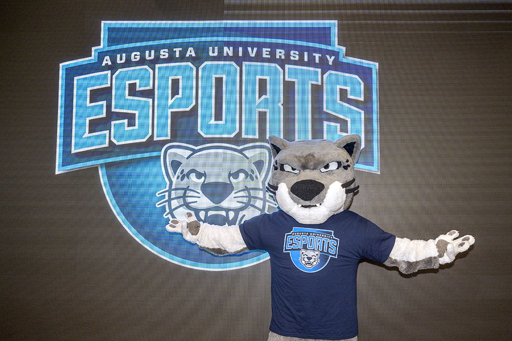 Mascot standing in front of a screen