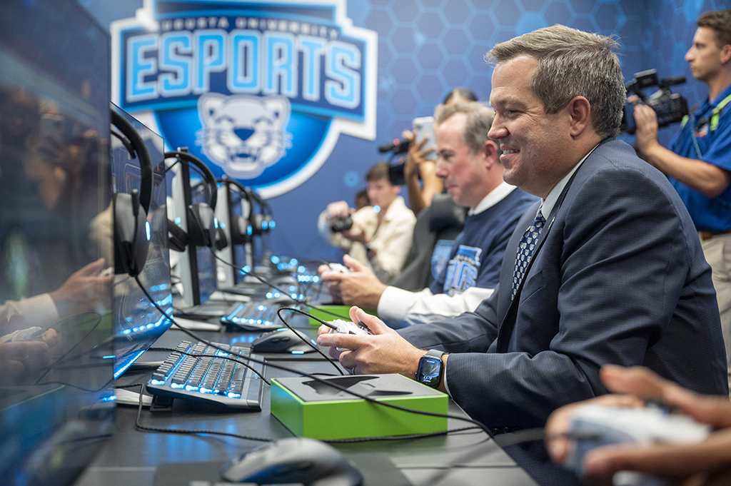 Men and women playing video games in new facility