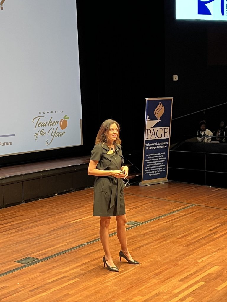 woman speaking to students in a theater