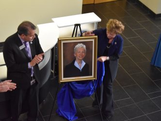 Kevin Velez and Debbie Layman unveil Dr. Marion's official portrait.