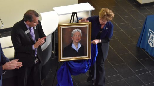 Kevin Velez and Debbie Layman unveil Dr. Marion's official portrait.