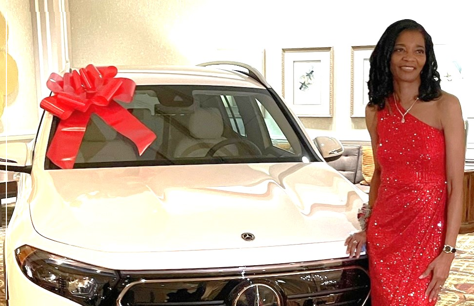 Woman standing with a car.