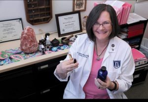 Dr. Langley Brady poses with essential oils she is working with