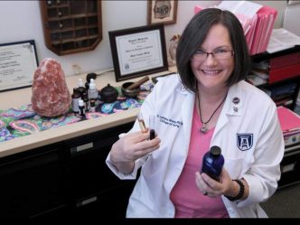 Dr. Langley Brady poses with essential oils she is working with