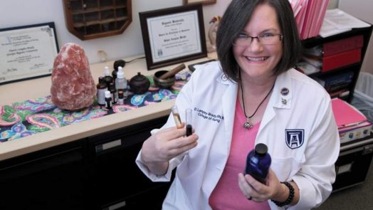 Dr. Langley Brady poses with essential oils she is working with