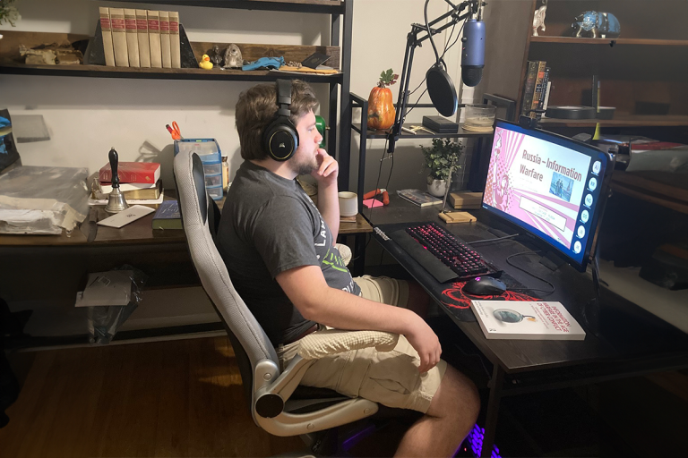 Man working at a computer and watching a presentation