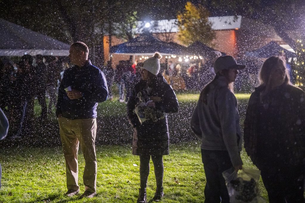 Three people are being showered in "snow"