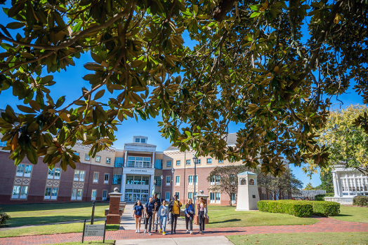 Students walk on Summerville Campus outside Allgood Hall